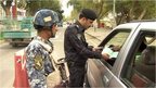 Iraqi security guards checking papers 