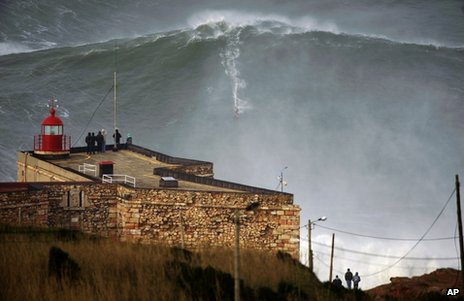 Big-wave surfer Garrett McNamara drops in on a large wave at Praia do Norte in Nazare, Portugal, 28 January 